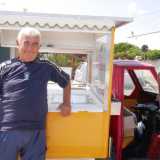 Donato posa con orgoglio accanto al nuovo tre ruote con frigorifero